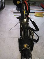 Black Callaway carry bag with stand up, holding golf clubs.