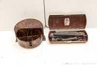 Bakelight trinket box and Welch Allyn veterinarian tool kit displayed side by side.