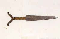 Full view of dagger laid flat showing blade, handle wrapping, and crossguard