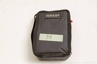 Closed BASF-branded grey carrying case with zipper and the number '35' label on front.