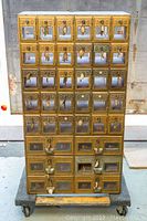 Front view of entire cabinet showing six columns in top four rows and four larger boxes in bottom two rows.
