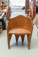 Front view of the antique pelican carved wooden chair showing the overall structure including the carved pelican heads as armrests.