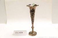 Front view of conical bud vase with filigree dragons and flared rim