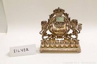 Front overall view of sterling silver menorah showing full nine-candle row and supporting lions