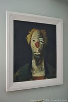 Framed clown print hanging on wall, showing entire artwork and frame with dimensions approximately 29x25 inches.