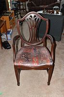 Front view of captain's chair with shield backrest and patterned fabric seat.