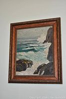 Framed oil painting on board hung on a wall, showing the full seascape artwork and frame.