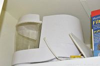 Photo showing the Honeywell 2-gallon natural cool moisture humidifier with a see-through water tank and white base unit.