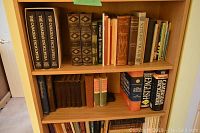 Top of four shelves showing three-volume Canadian Encyclopedia in slipcase and assorted history/reference books