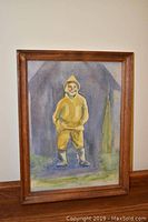 Full frontal view of the framed watercolour print depicting a child in yellow rain gear against a bluish background.