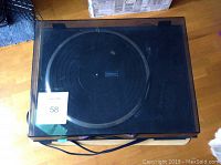 Kenwood turntable with dust cover closed showing overall condition and power cord