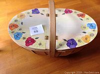 Full view top of closed basket showing colorful handpainted floral design around the rim.