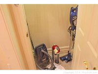 Photo of two vacuums and Sodastream maker in a narrow closet space
