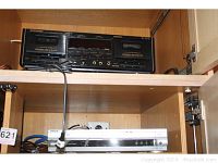 Pioneer Elite CT W53 cassette deck and Sony DVD VHS player inside wooden cabinet, showing both units stacked.