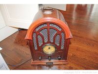 Full frontal view of the Thomas Classic Series Model 611 radio showing wooden cabinet, speaker grille, analog dial, and control knobs.