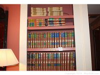 Bookshelf with multiple Britannica Great Books volumes neatly arranged with leather bindings