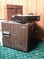 Wood grain Samsung mini fridge with JVC VCR and wooden storage box on top