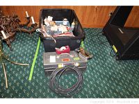 Wide view of toolbox, tray, metal toolbox, and extension cord laid on carpet