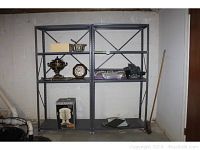 Two metal shelving units showing full height and width with some items on shelves removed. Both shelves have four levels and X-shaped metal braces across back panel.