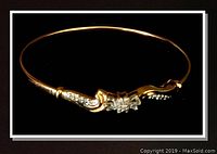 Full view of the 10K gold bangle on black background