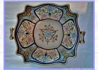 Top view showcasing handpainted floral designs with gold trim and scalloped edges.