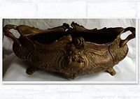 Front view of ornate solid brass planter