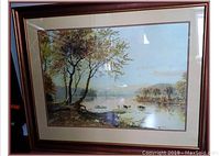 Framed landscape print depicting lake with trees, cows, boat, and mountains in the background.