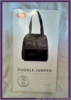 Front of original product box showing image of the black Lug Puddle Jumper bag and brand name.