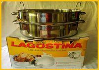 Photo shows the large stainless steel roasting pan stacked with removable chrome-plated rack placed on original box with Lagostina branding.