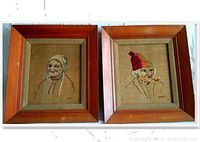 Pair of framed needle paintings showing close-up portraits of a female and male Quebec habitant from 1830, signed by Anne-Marie Matte Derosier. Frames show wear and scratches.