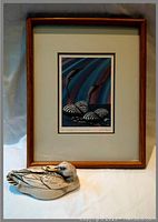 Framed print of Arctic Loons titled "The Twilight Arc" by Rick Beaver with duck trinket box beside it.