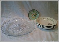 Photo showing four Lenox pasta bowls with butterfly and leaf design, and one small handpainted floral plate behind them, all set on a fabric surface.