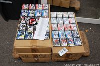 Five cardboard boxes on a pallet with stacks of Slam Cards sports trading cards on top, showing full-color action images and player names.