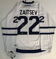 Full back view of white Reebok hockey jersey with player name 'Zaitsev' and number '22' in navy blue. Signature visible on number.