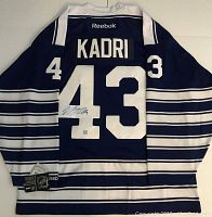 Back side of navy blue Toronto Maple Leafs hockey jersey with 'KADRI' and number '43' in white, signed by Nazem Kadri.