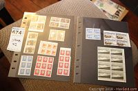 Two album pages showing multiple blocks of uncirculated Canadian stamps in sleeves