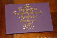Outer presentation box with gold embossed title 'The Courage of Great Britain & Northern Ireland 1980' on purple background.
