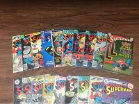 Front view of a set of Superman comic books spread out showing colorful covers, mostly from the 1960s-1980s era.