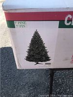 Box showing an image of the artificial pine Christmas tree and labeling it as 7' (7 foot) pine tree.