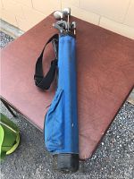 Blue kids golf club carry bag showing side pocket and shoulder strap.