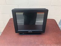 Black Eclipse branded touchscreen monitor front view on table.