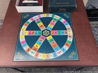 Game board laid flat showing colored question category spaces and wheel center.