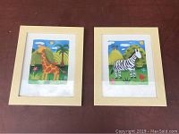 Two framed kids pictures showing a giraffe and a zebra in colorful cartoon style.