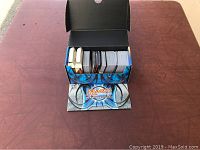 Magic: The Gathering cards organized inside the Deck Builder's Toolkit box showing multiple decks and loose cards.