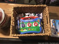 Top view of the Word Whammer electronic educational toy and magnetic letters in woven basket