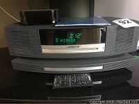 Front view of Bose Wave SoundTouch unit with green LED display showing time and preset.