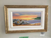 Framed landscape painting with rocks and water scene, signed by A.J. Curran at bottom left, displayed on wall.