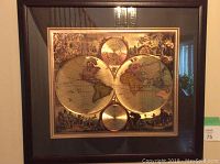 Front view of the framed vintage style world map print with black frame and glass cover.