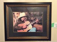 Front view of framed Alan Jackson print showing subject playing acoustic guitar while wearing cowboy hat.