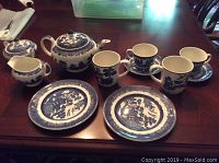 Full view of the tea set arranged on wood table showing all pieces